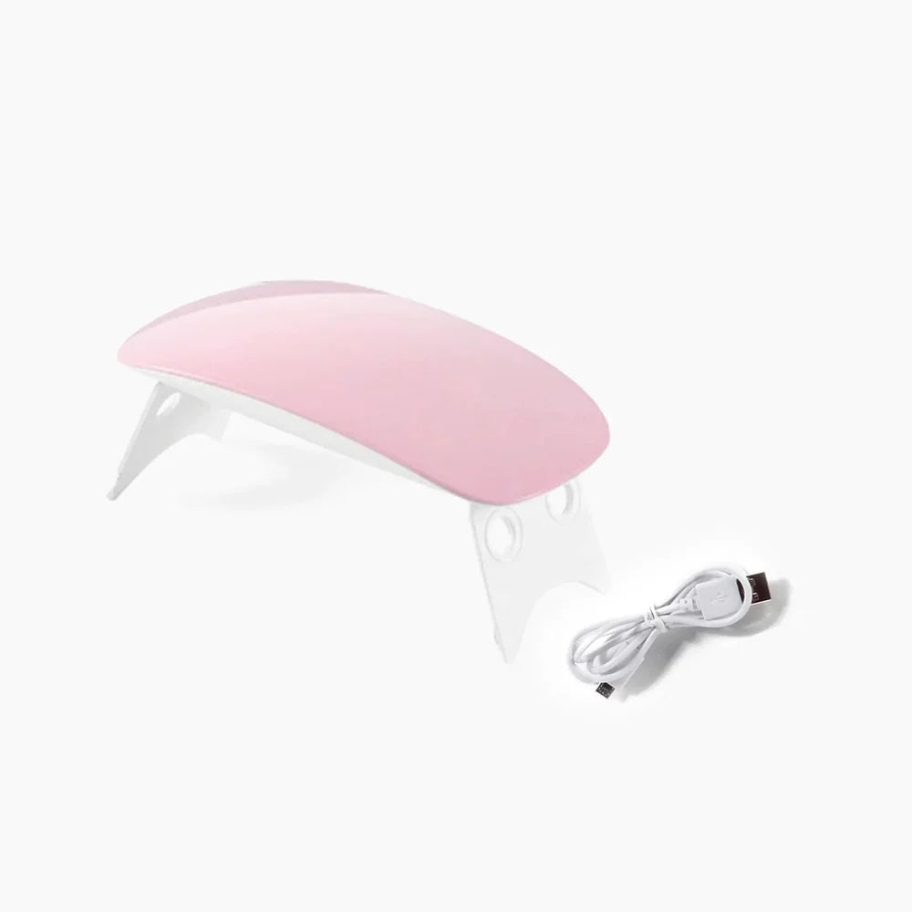 Mini UV nail dryer with pink curved cover and power cable