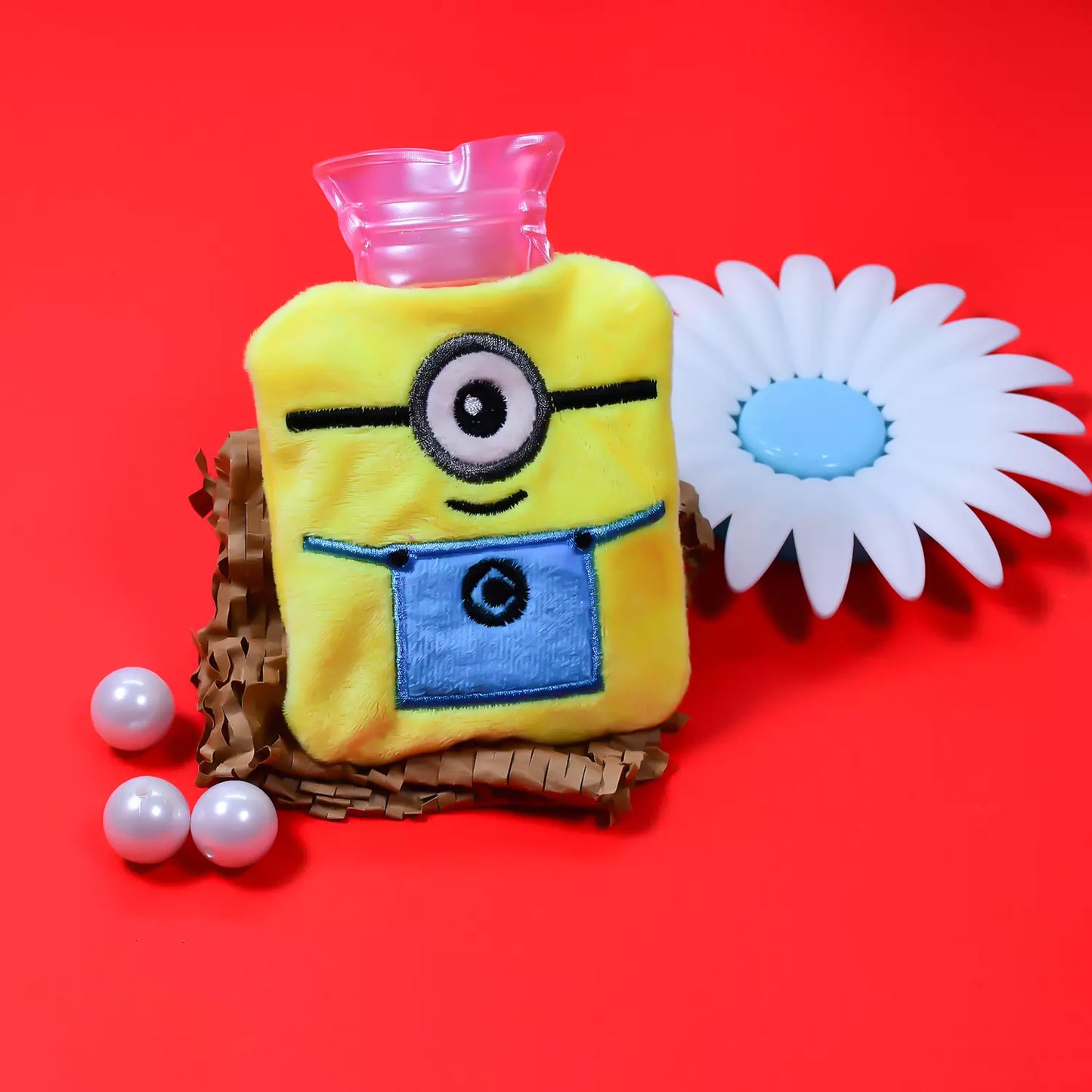 Minions hot water bottle with soft cover, yellow plush minion face and blue overalls