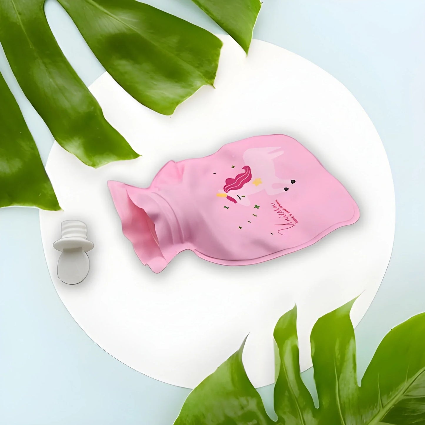 Pink mini hot water bag with unicorn-style illustration and white screw cap