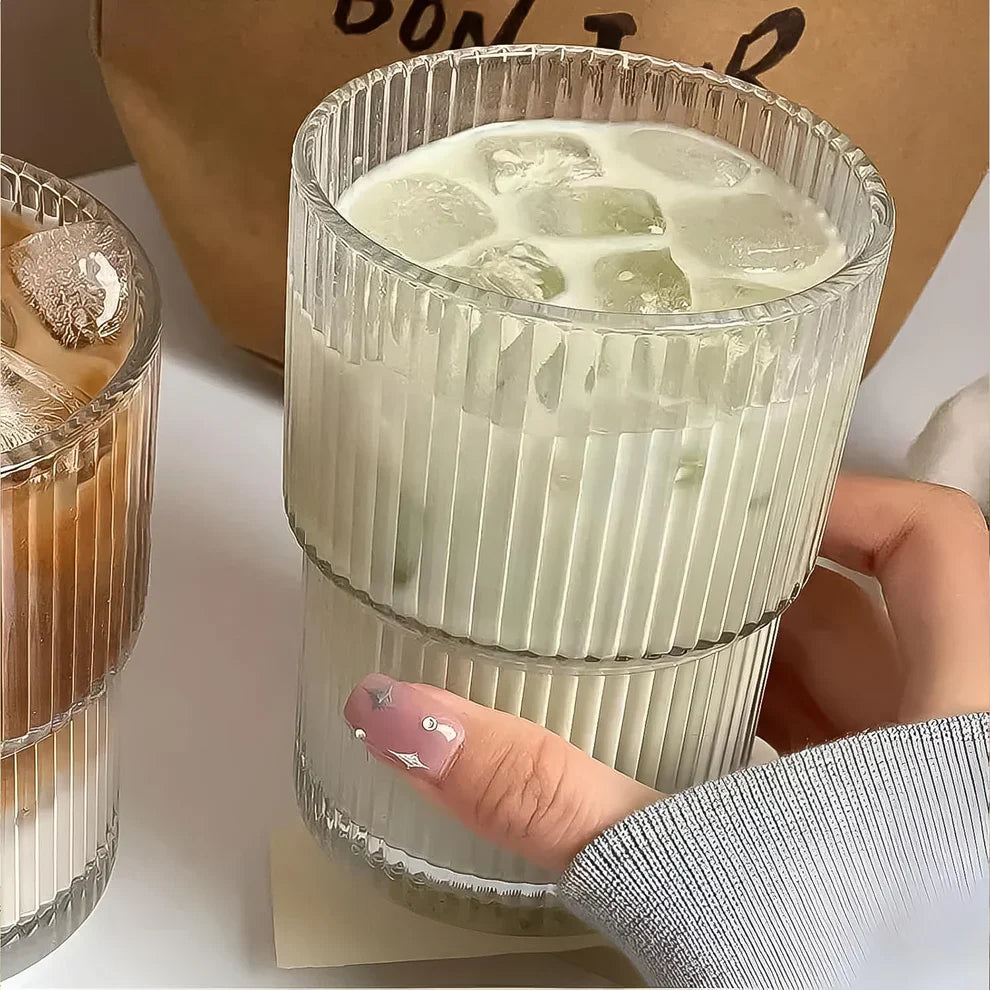 Ribbed transparent 450ml tumbler cup with ice cubes, held in a hand