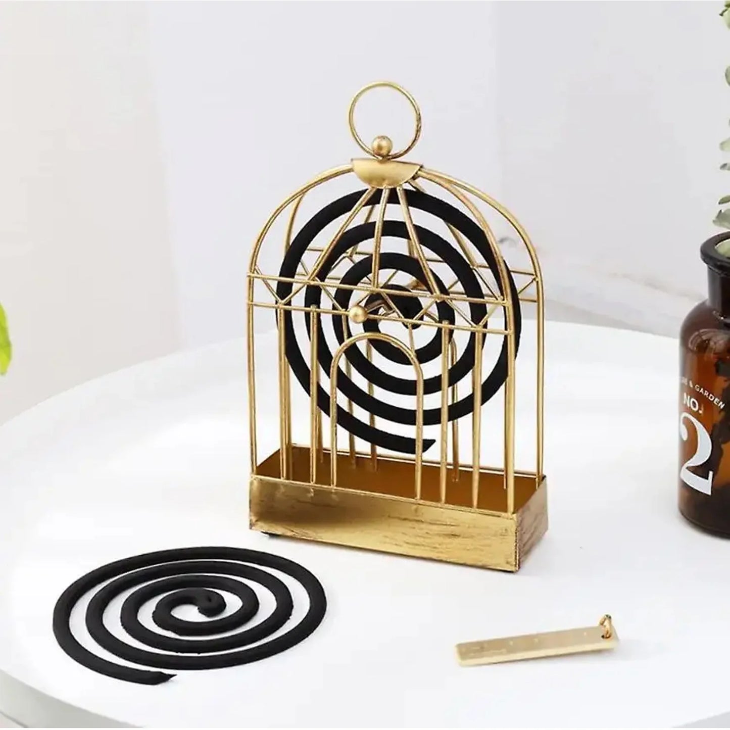 Mosquito coil holder with gold wire cage, spiral coil and incense stick