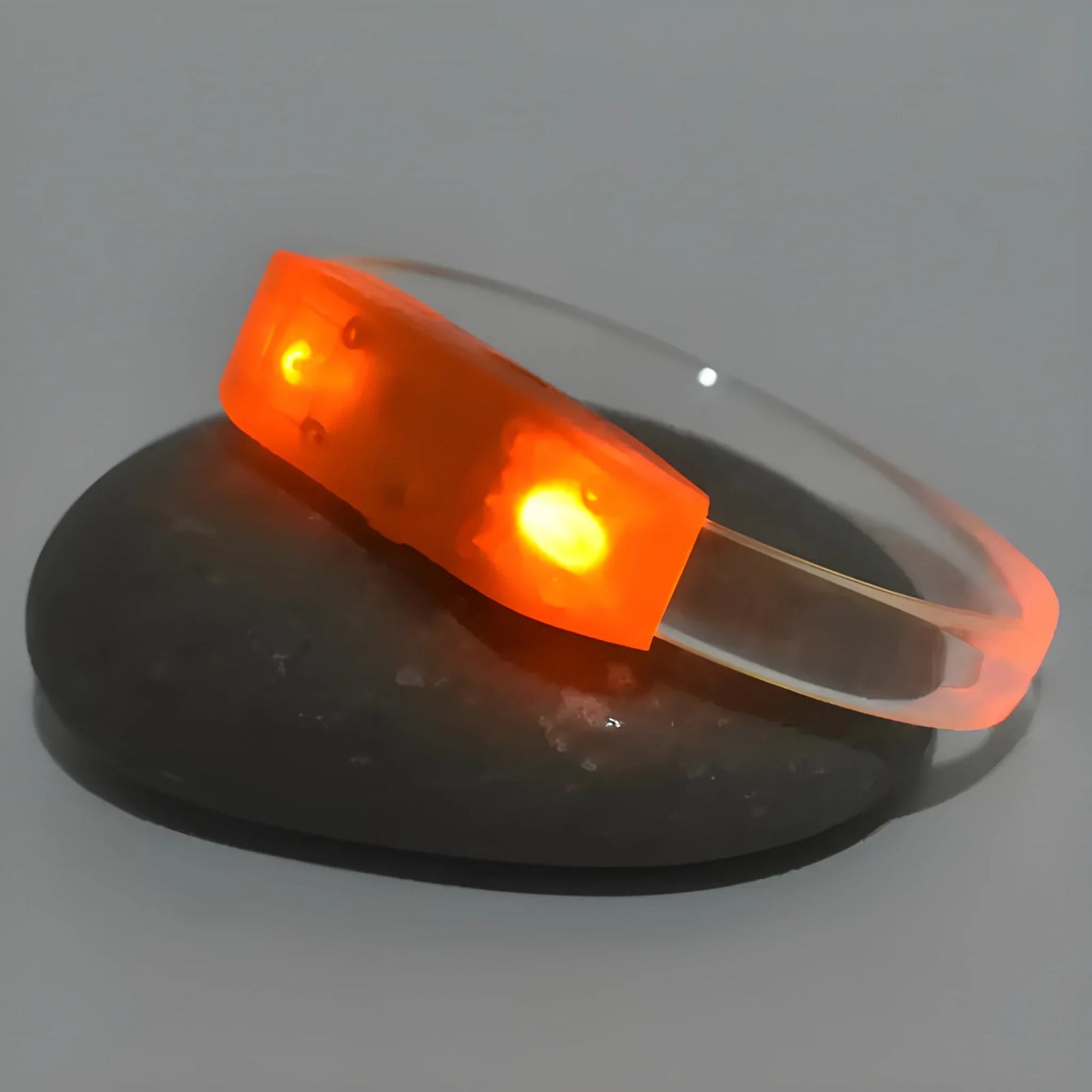 LED bracelet with glowing orange light band and flexible black strap