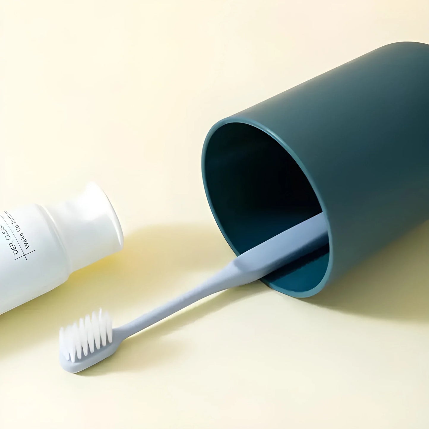 No-drill toothbrush organizer with teal cup holding a toothbrush