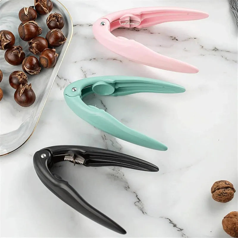 Nutcracker clip tools in pink, mint, and black with metal teeth for cracking nuts