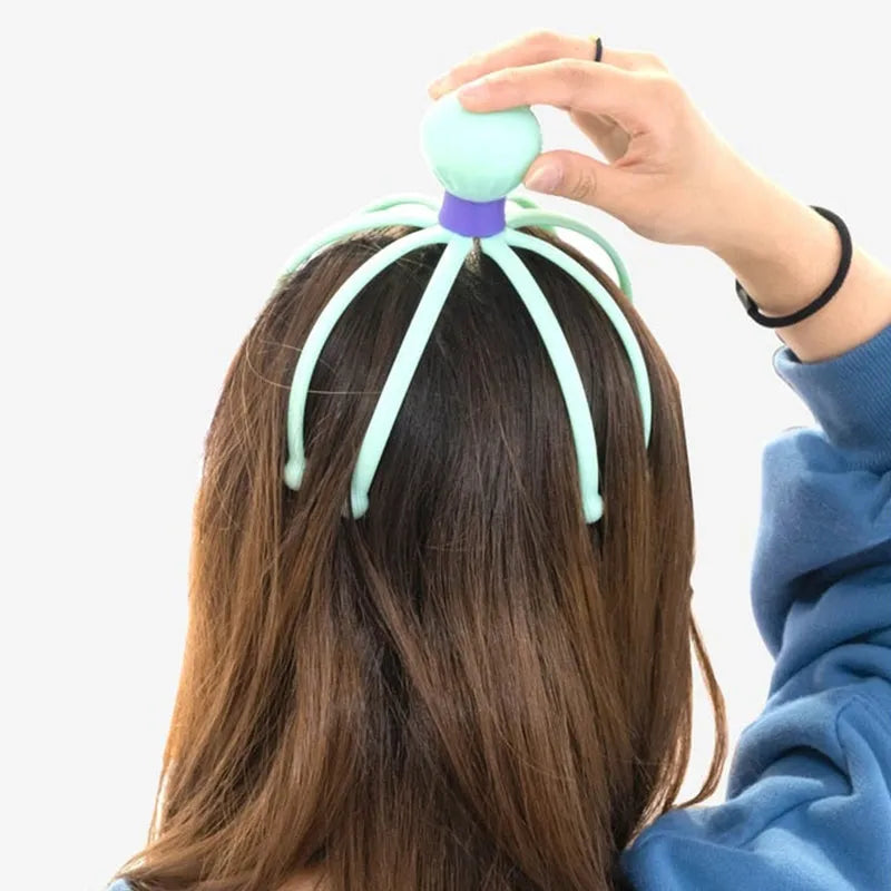 Octopus scalp massager with teal octopus head and tentacle fingers held to hair