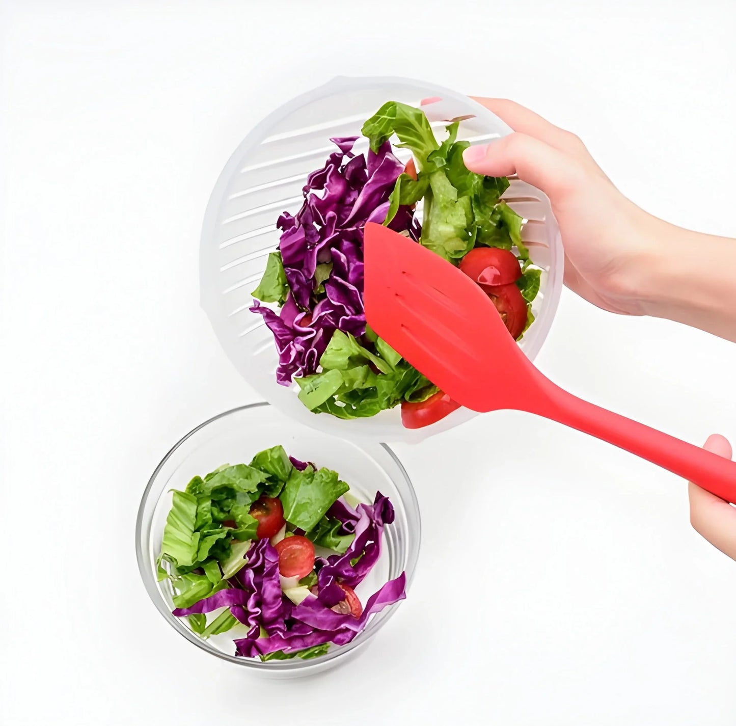 Plastic salad cutter with red scoop, shredding leafy greens into a bowl