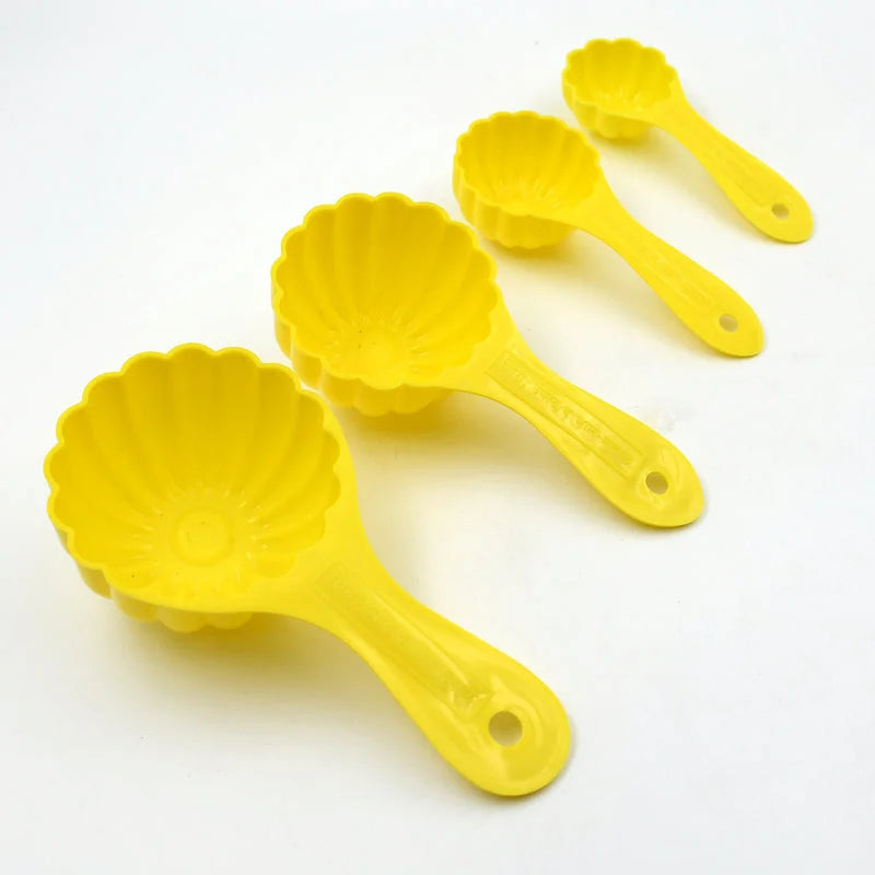 Ladoo mould set with four yellow flower-shaped molds and handles