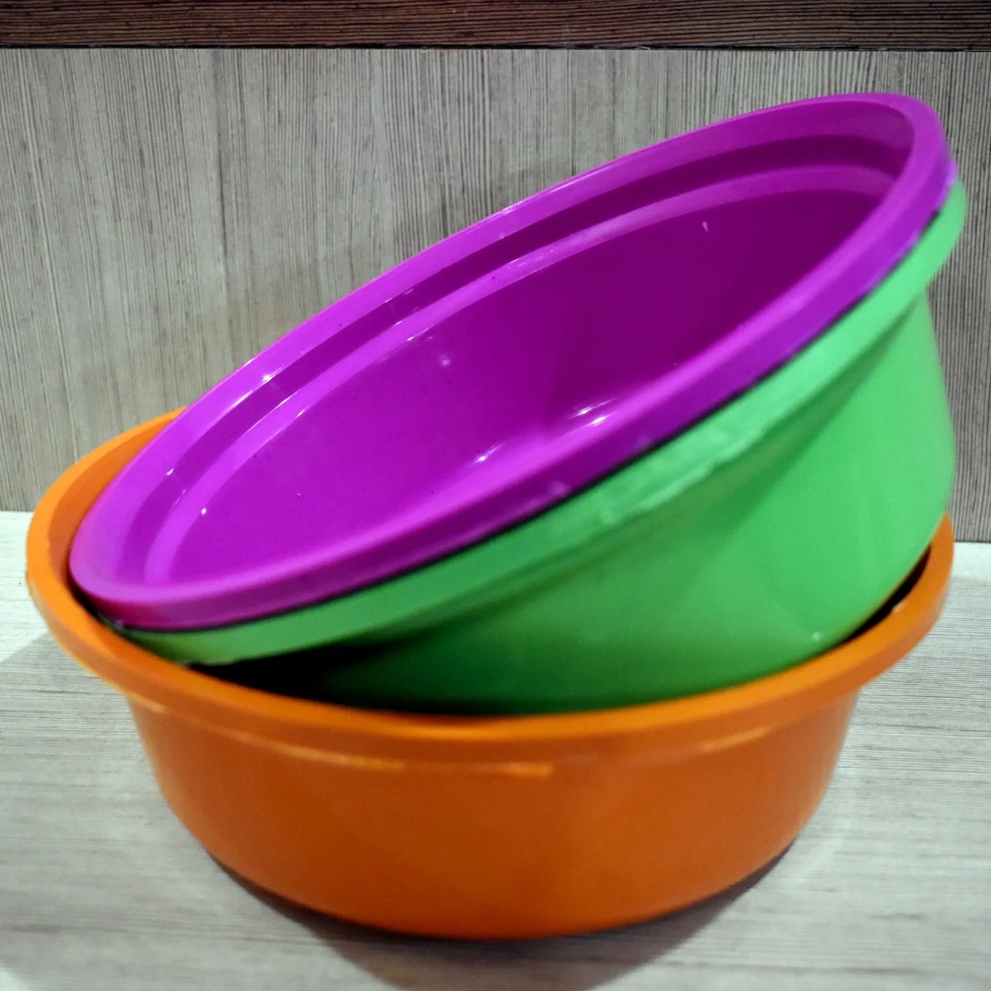 Plastic storage tub set with orange tub, nested purple and green tubs