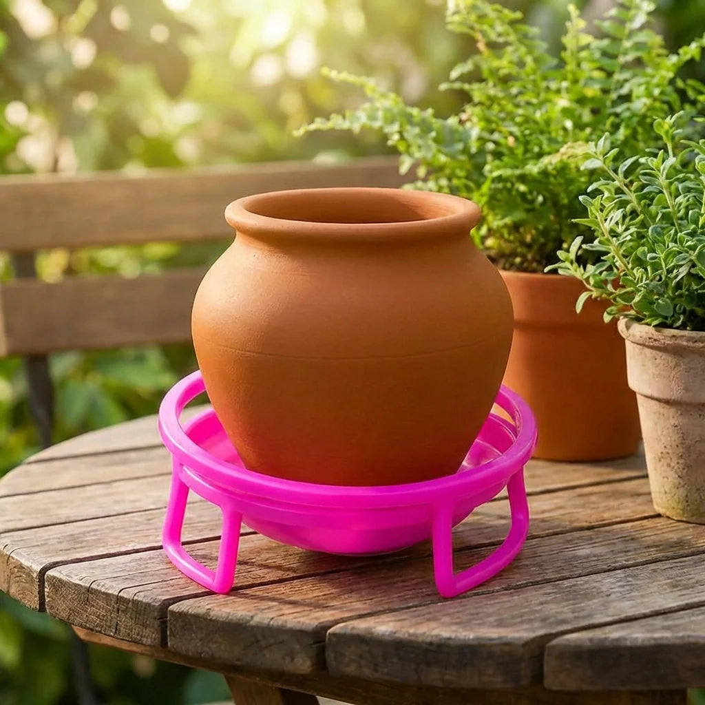 Purple plastic water pot stand with terracotta flower pot on top