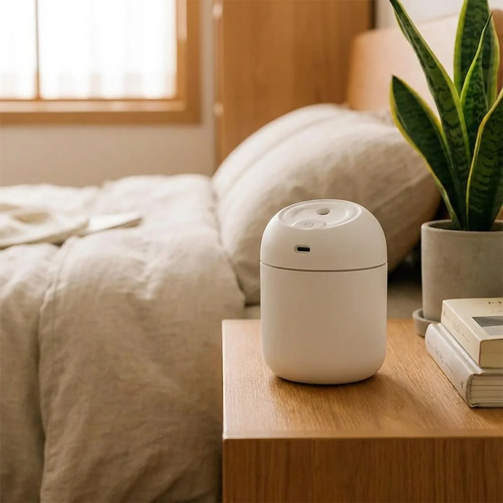 Small white portable humidifier with built-in lighting top, compact tabletop design