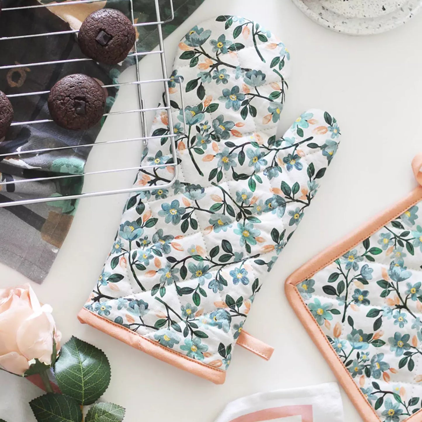 Floral cotton oven mitt with leafy pattern and long cuff, hanging loop