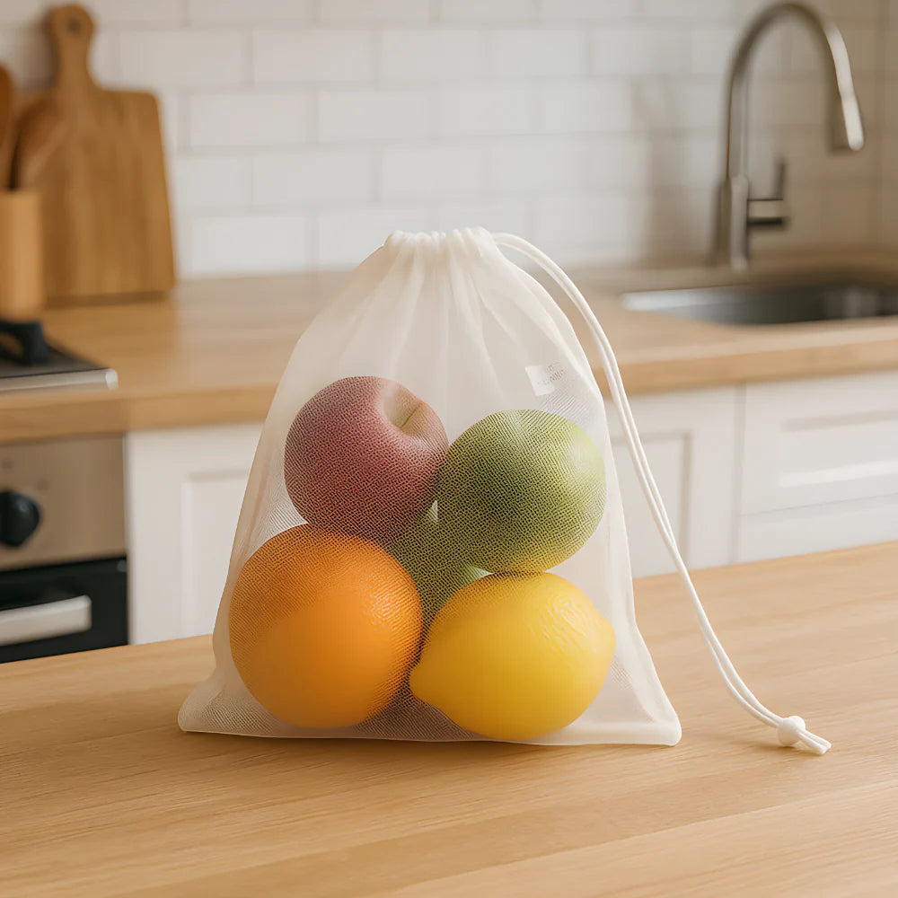 Reusable produce mesh bag with drawstring, filled with assorted fruit