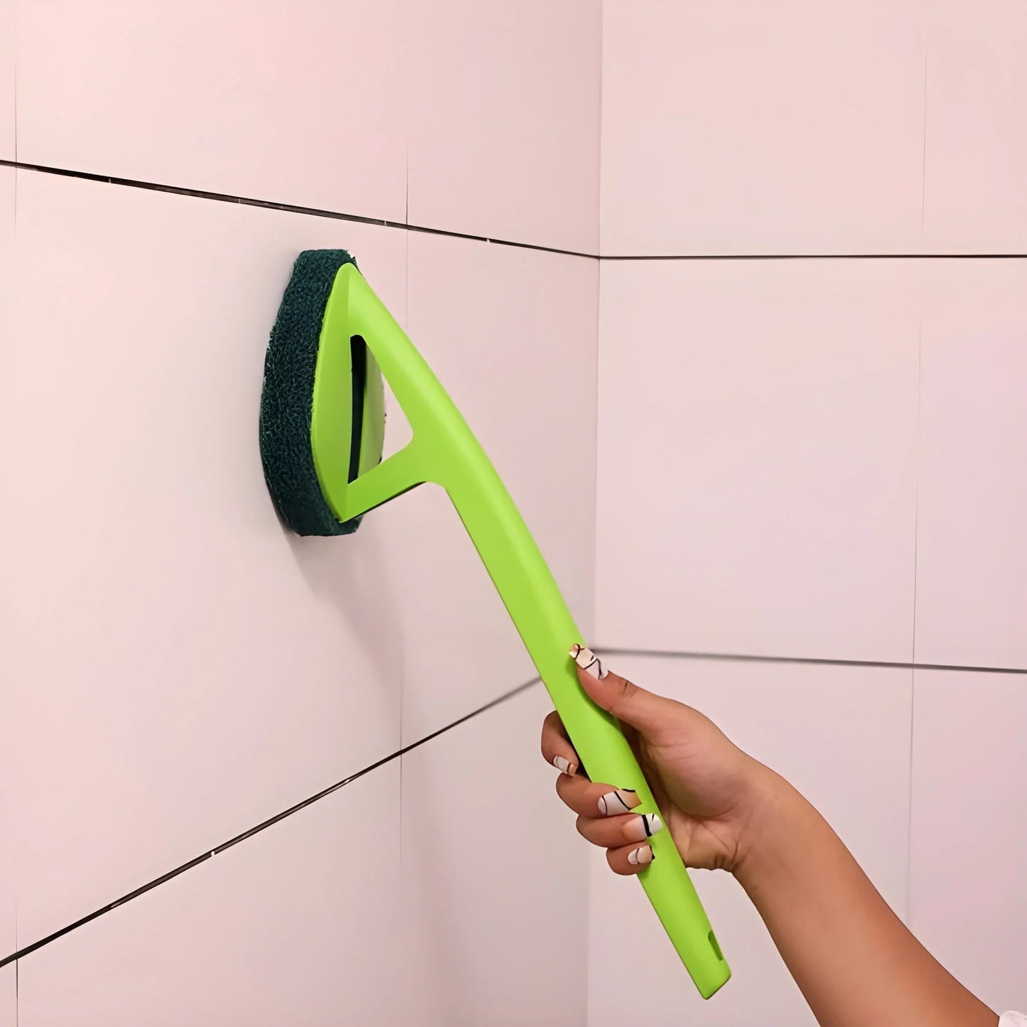 Long-handle hockey-style floor scrubber with bright green handle and dark foam head