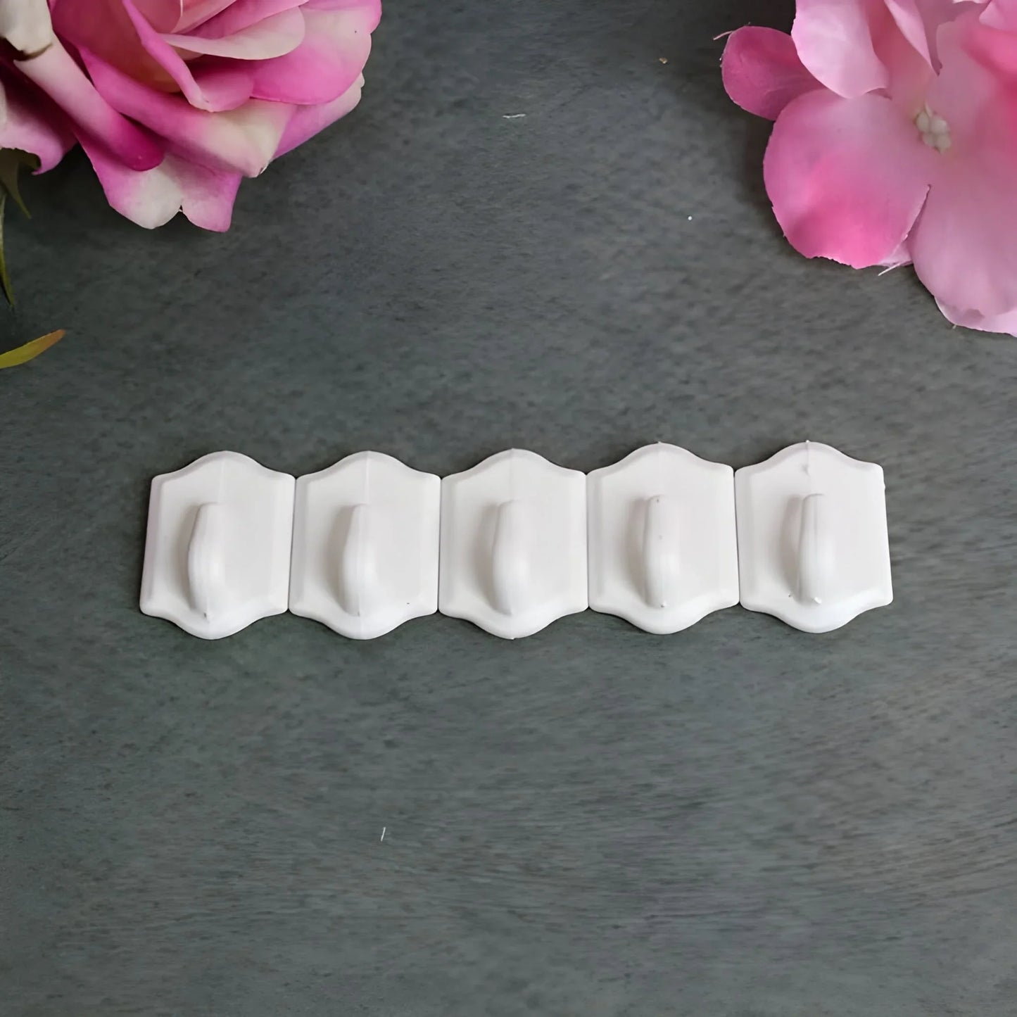 Set of small white wall hooks with curved ends