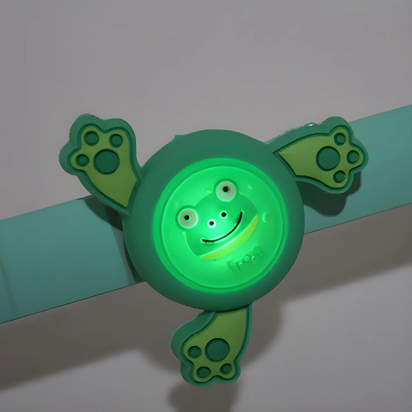 Green smart AR glow bracelet with smiling face.