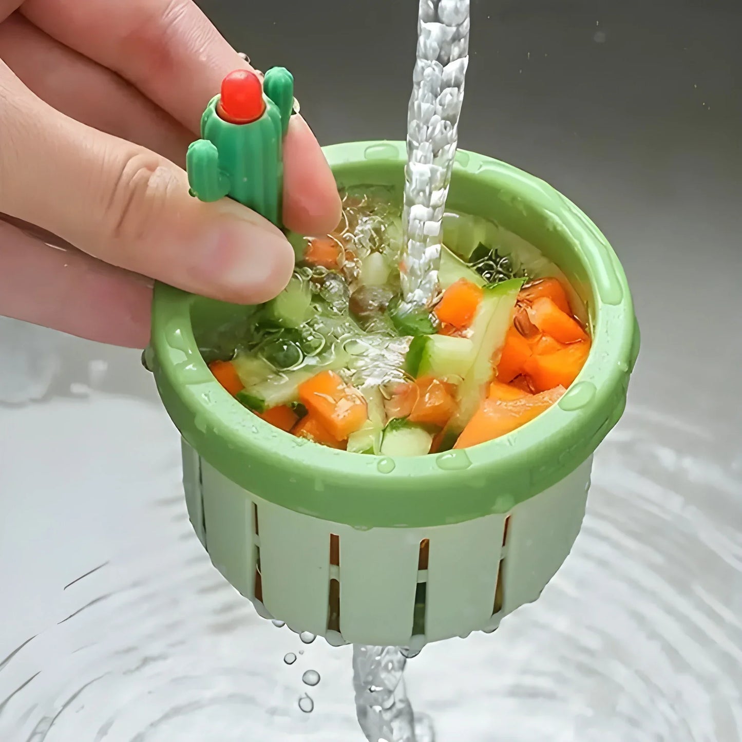 Green Smart Eco strainer basket, hand holding as water drains