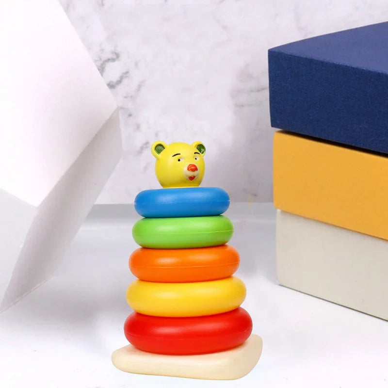 Stacking ring toy with bear face topper and five colorful rings: blue, green, orange, red, yellow.