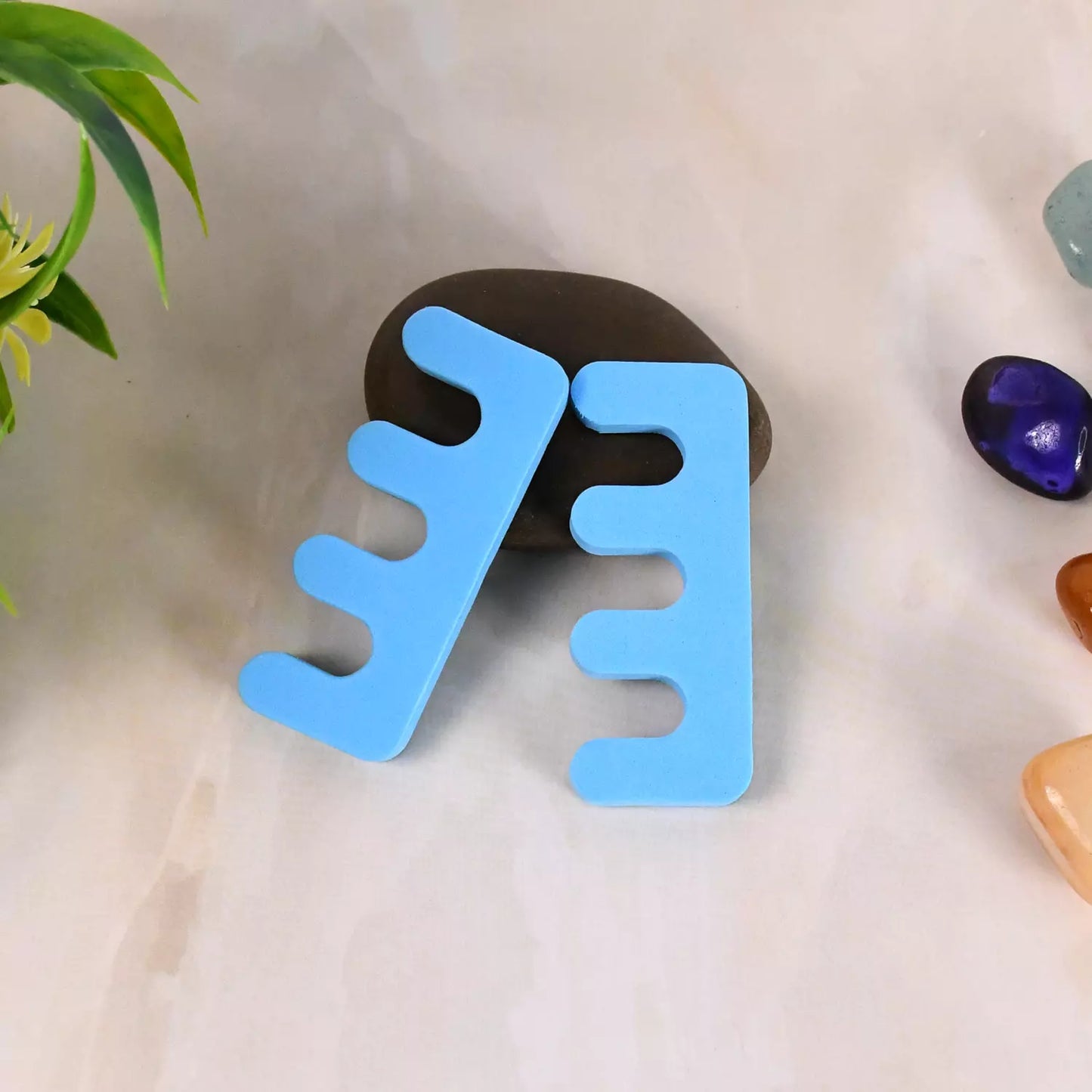 Blue silicone toe separators with four split pads for toes