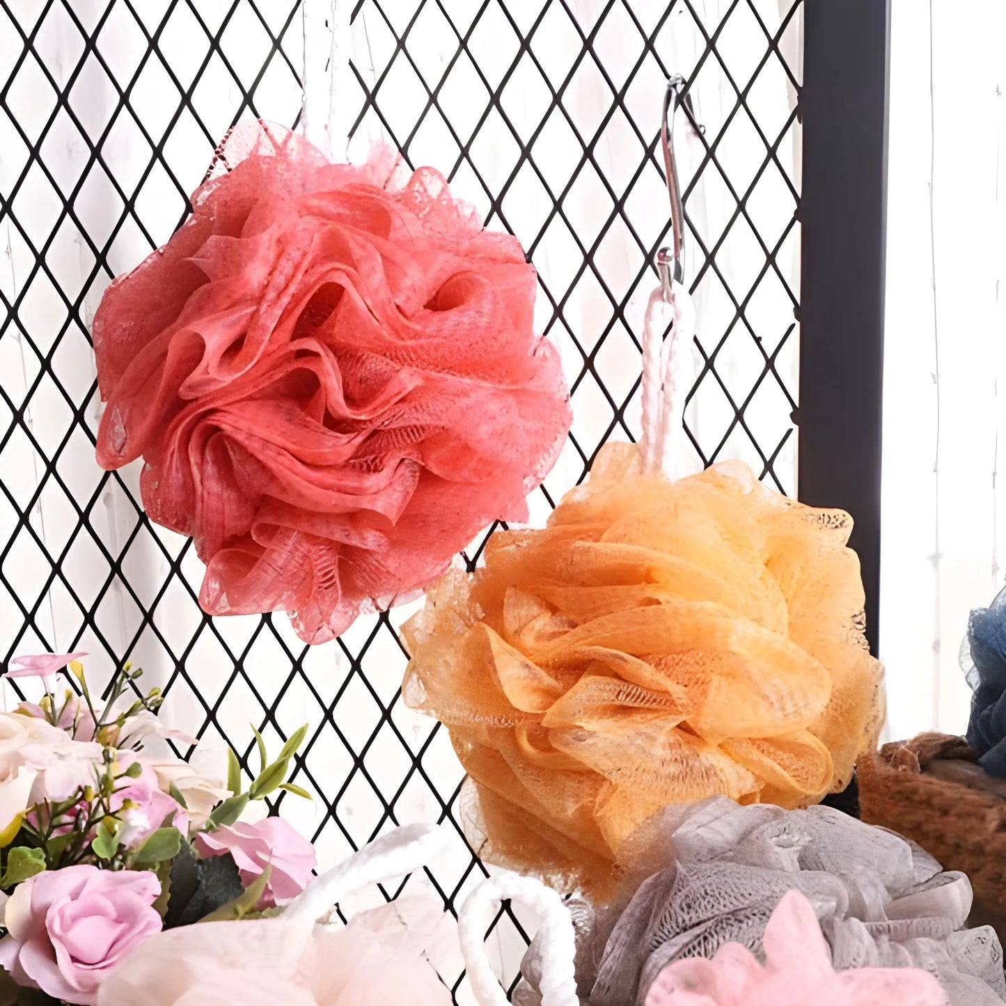 Exfoliating loofah puff with layered mesh, coral pink and orange flower shape