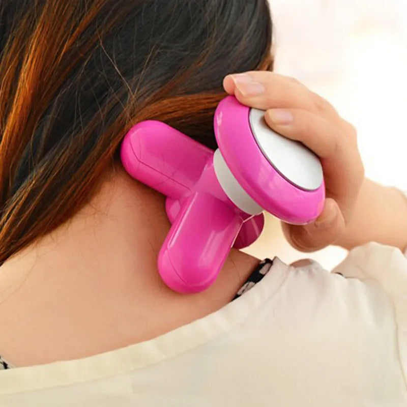 Pink full body handheld massager with white head, pressing on neck and shoulder