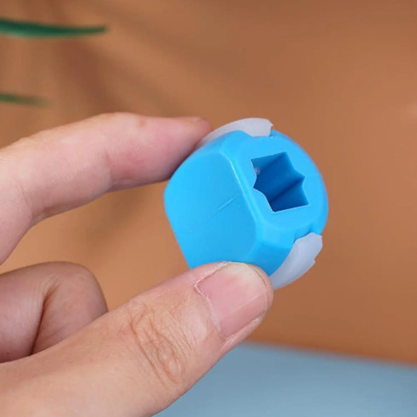 Blue jaw exerciser device with star-shaped center opening