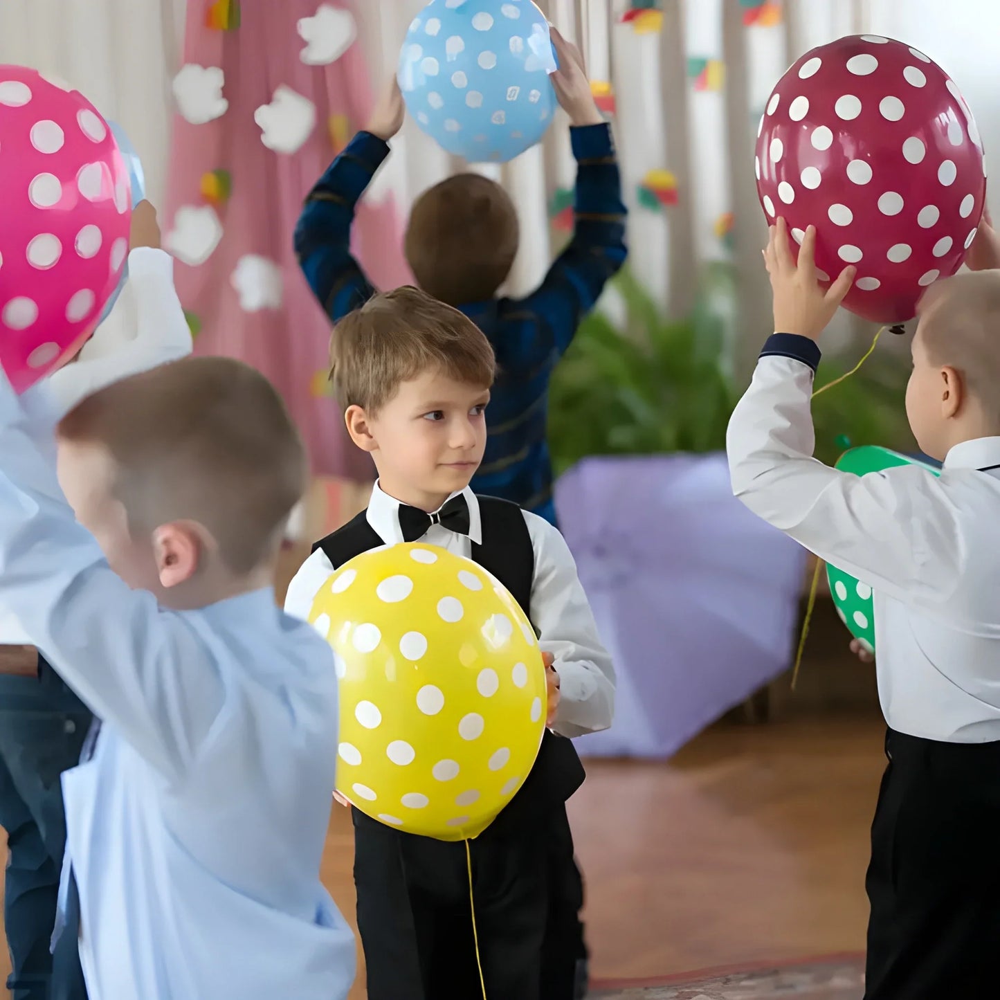 Latex party balloons set with polka dots in pink, blue, yellow, and green