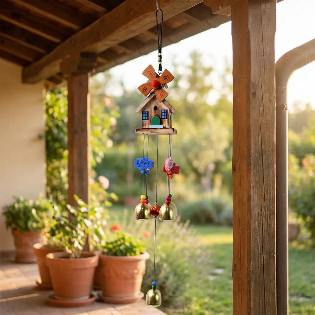 Outdoor wind chime with dragonfly topper, house ornaments, and hanging metal bells