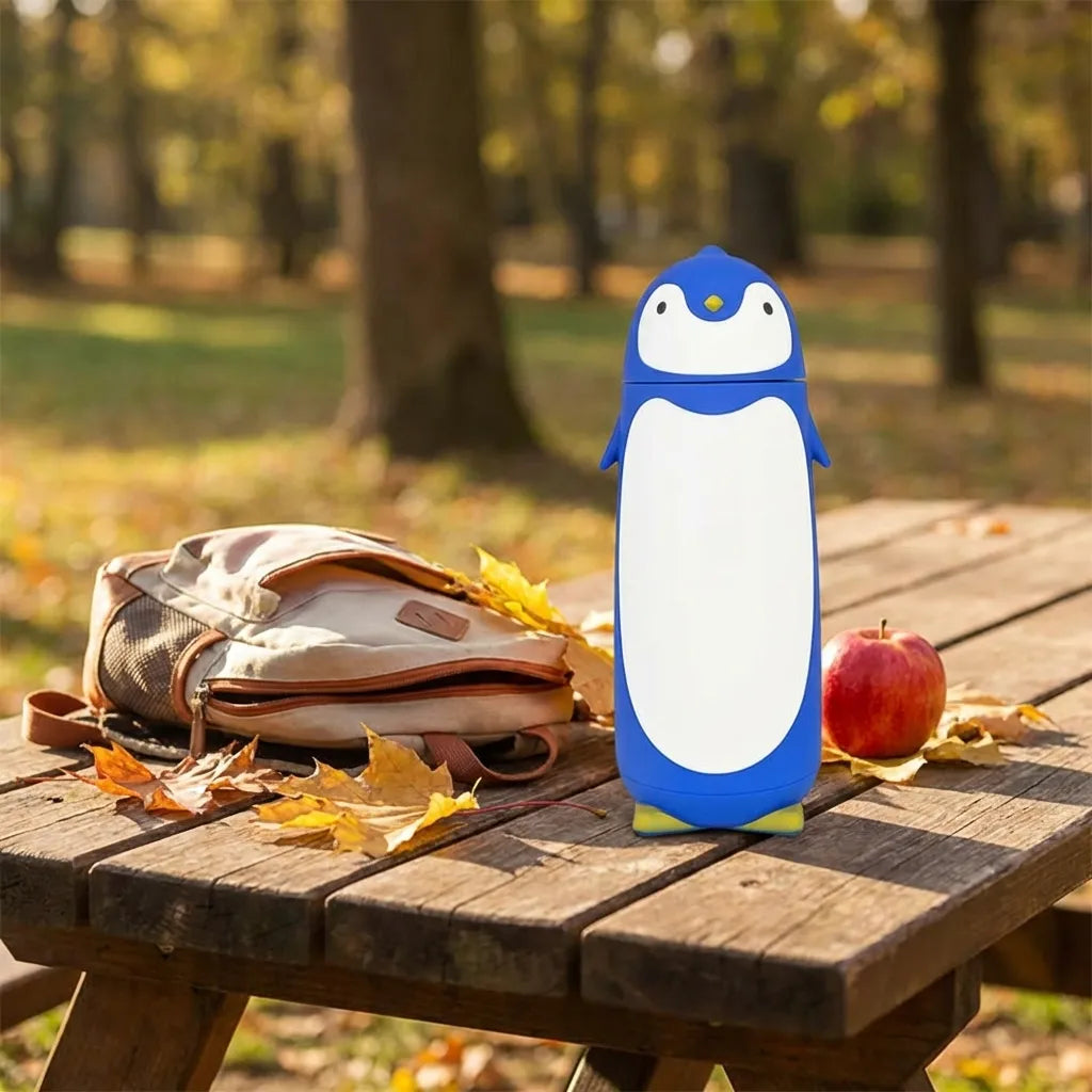 Penguin cartoon water bottle, white and blue penguin design with cap.