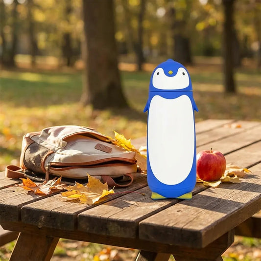 Penguin cartoon water bottle, white and blue penguin design with cap.