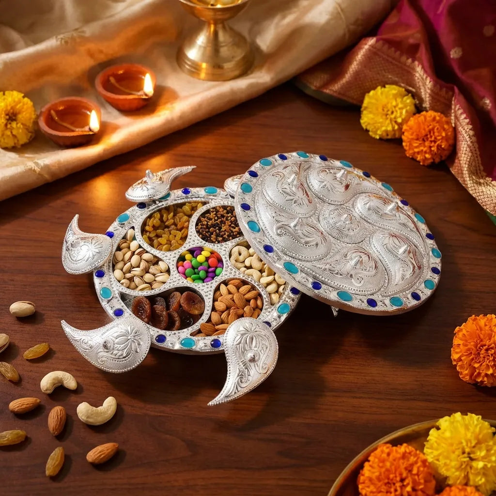 Silver 7-compartment dry fruit serving tray with open sections, blue studs, and carved rim