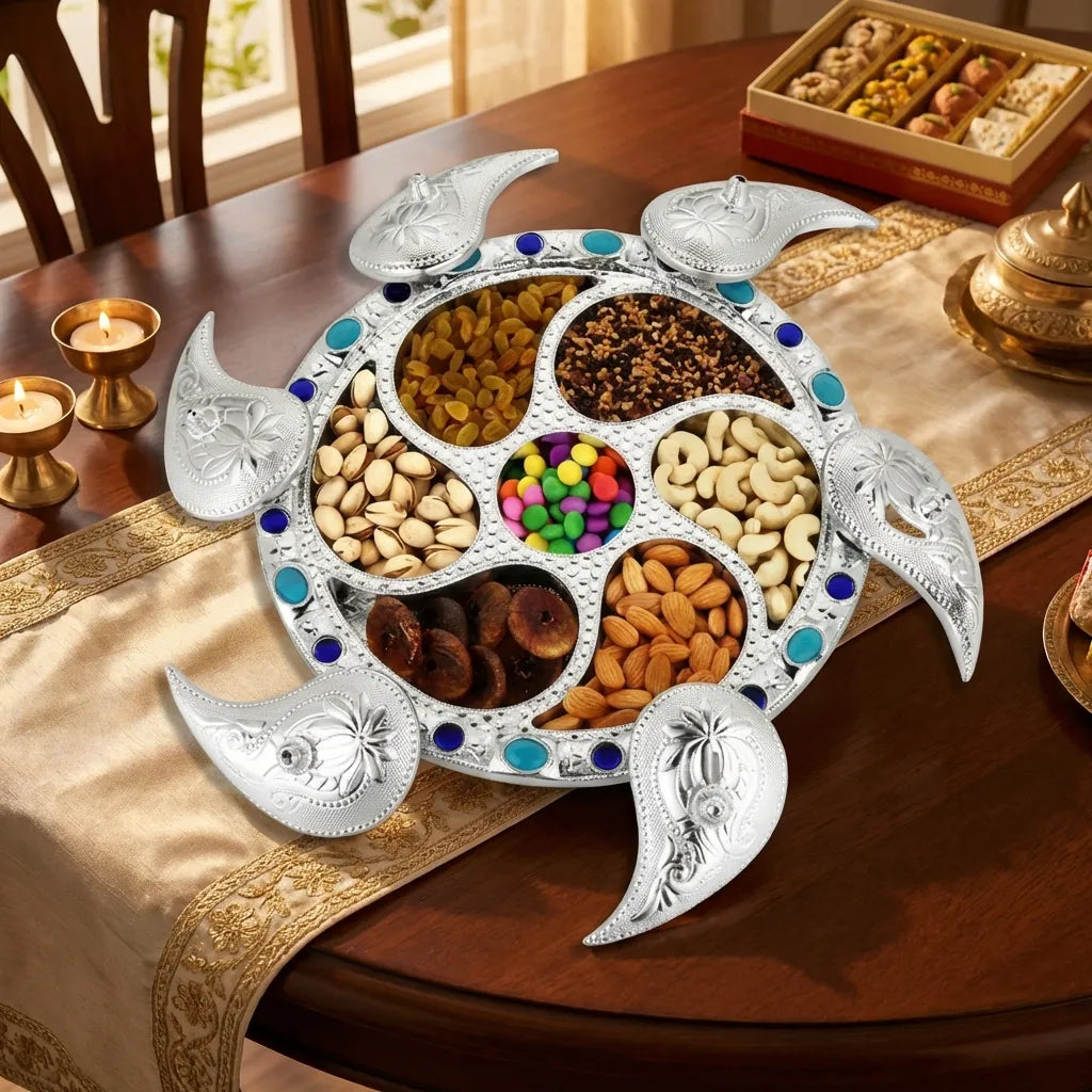 Silver 7-compartment dry fruit tray with open compartments and blue oval accents around rim