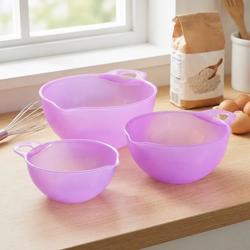 Three purple prep bowls with loop handles and pouring spouts, grouped on countertop.