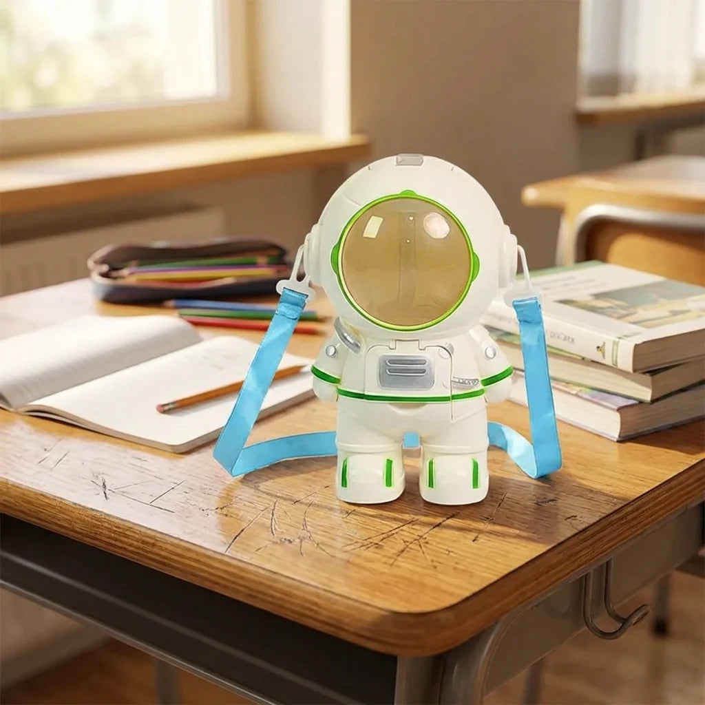Astronaut-shaped water dispenser with open visor and blue side handles on wooden table