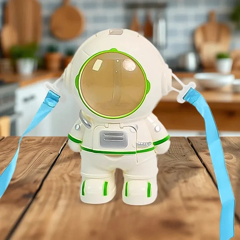 Astronaut-shaped water dispenser with blue side arms and green-trimmed round visor
