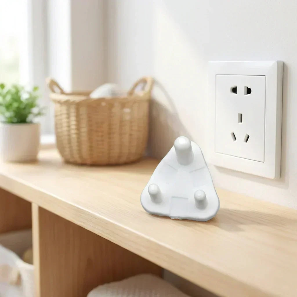 White baby socket cover on a tabletop near a wall outlet