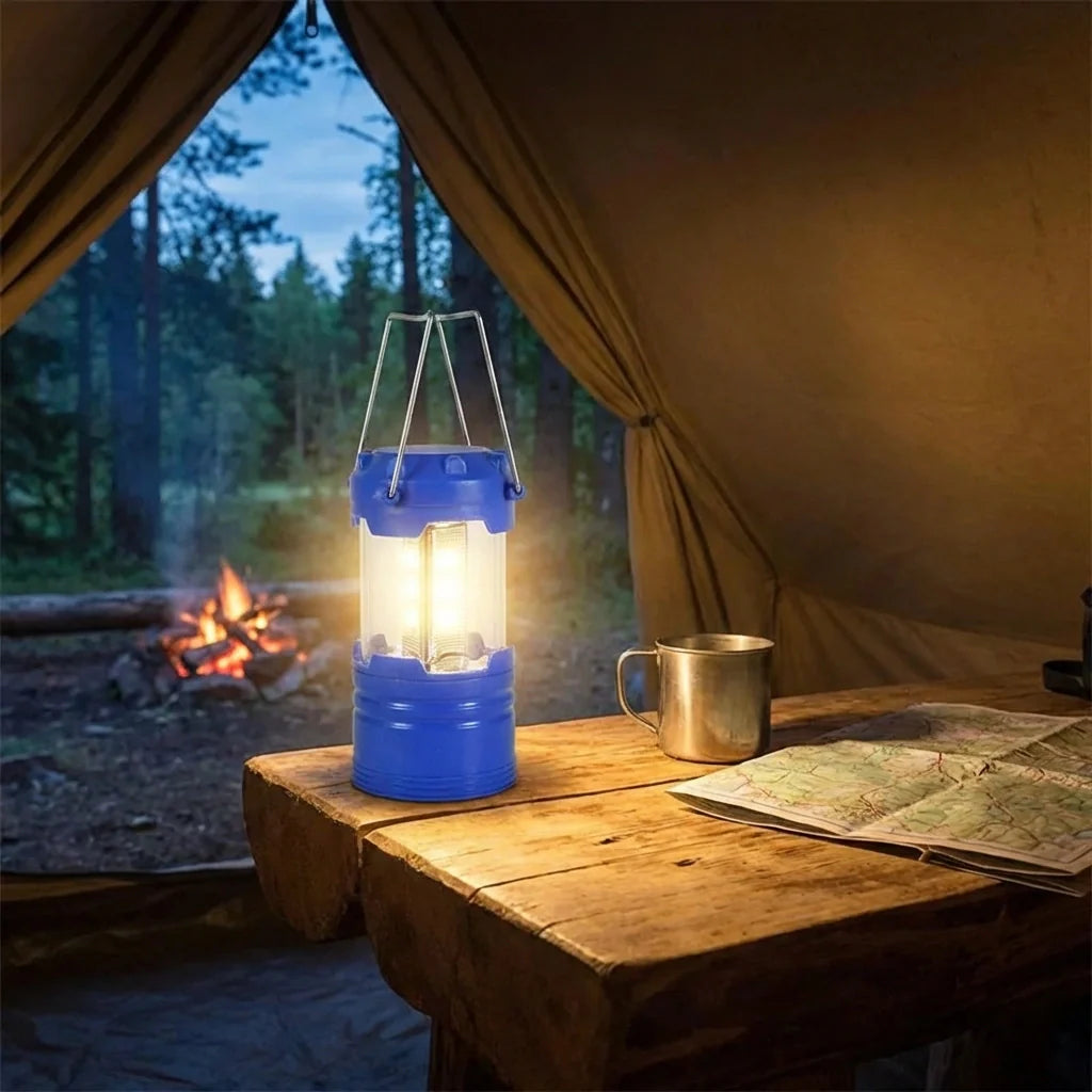Blue camping lantern with clear chimney and metal handle