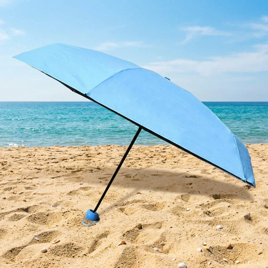 Light blue foldable umbrella, open, with black ribs and handle.