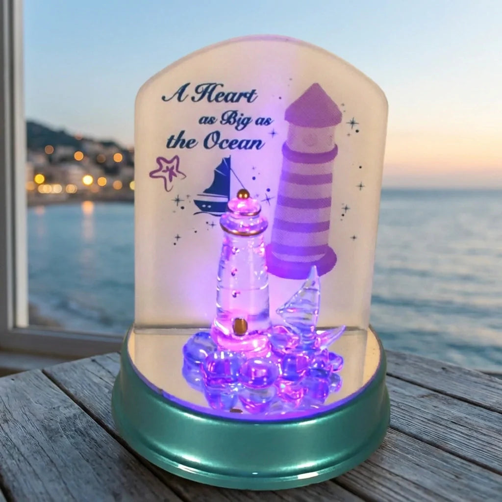 Cartoon LED night light with purple glowing lighthouse under clear dome