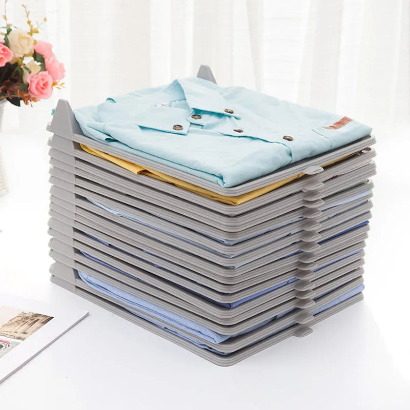 Cloth organizer holding a stack of folded light blue shirts