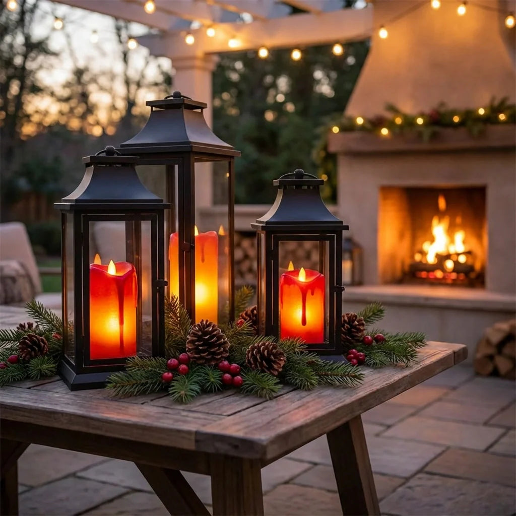 Flickering LED tea light candles in black lanterns with glass panels, warm orange glow