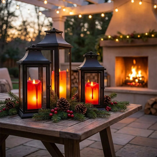 Flickering LED tea light candles in black lanterns with glass panels, warm orange glow