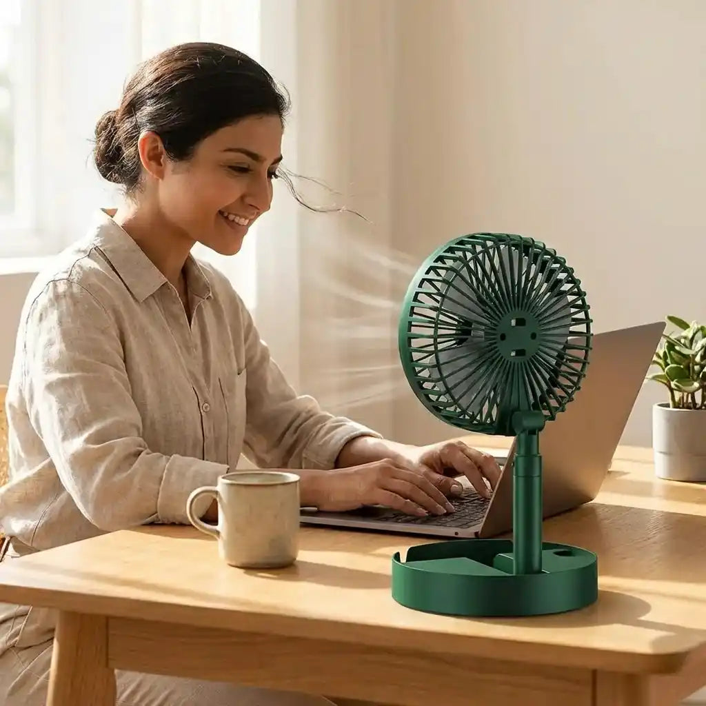 Green foldable telescopic fan standing on round base, tilted circular grille