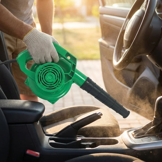 Green electric air blower with round intake fan and extended nozzle attachment