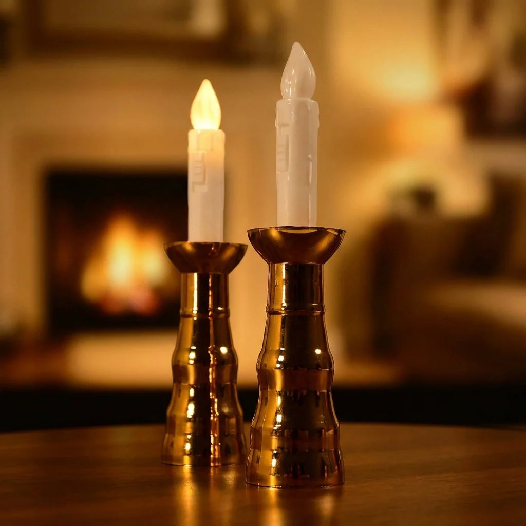 Pair of amber LED flameless candles with flickering flame tips on gold holders