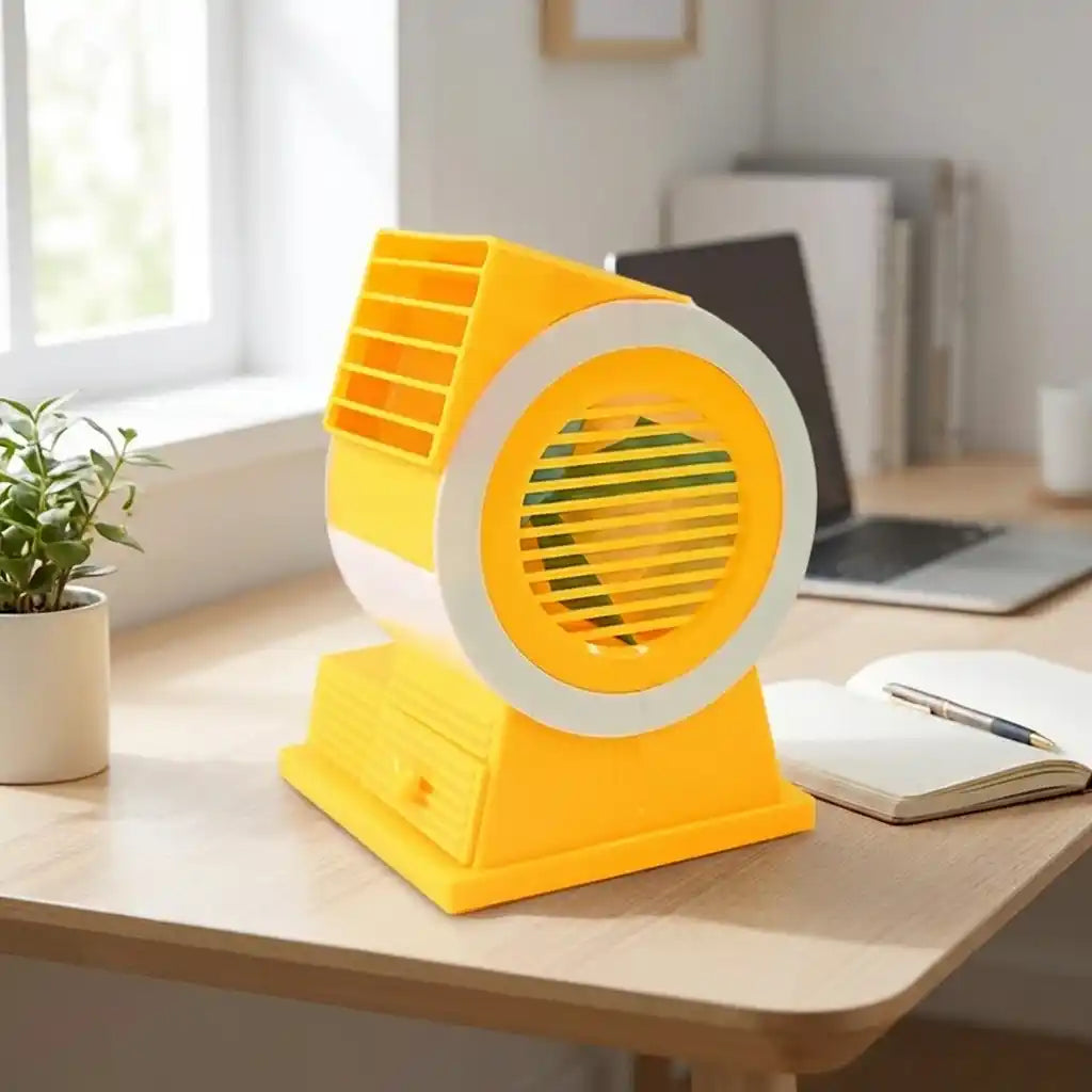 Mini USB fan facing left, yellow base and front grille with white circular ring.