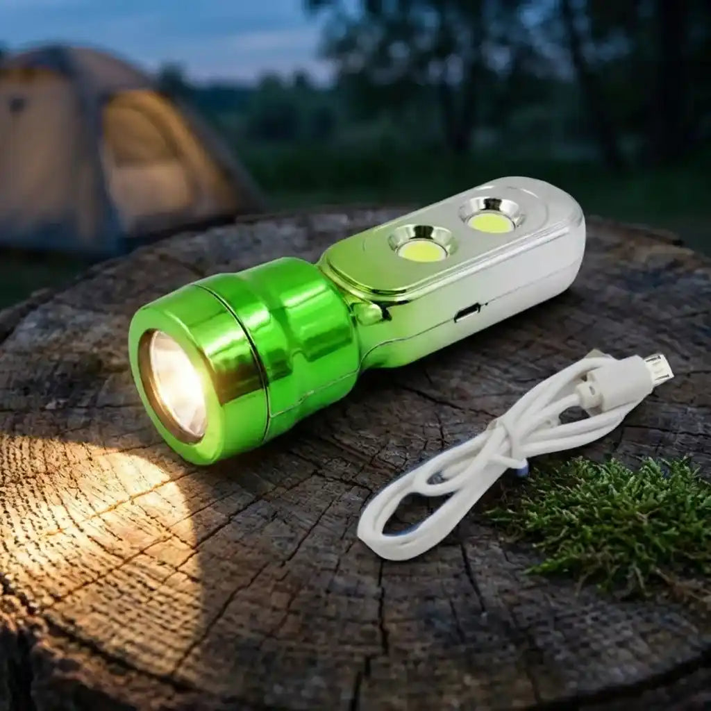 Green and silver multi-LED torchlight on wood log with white lanyard cable