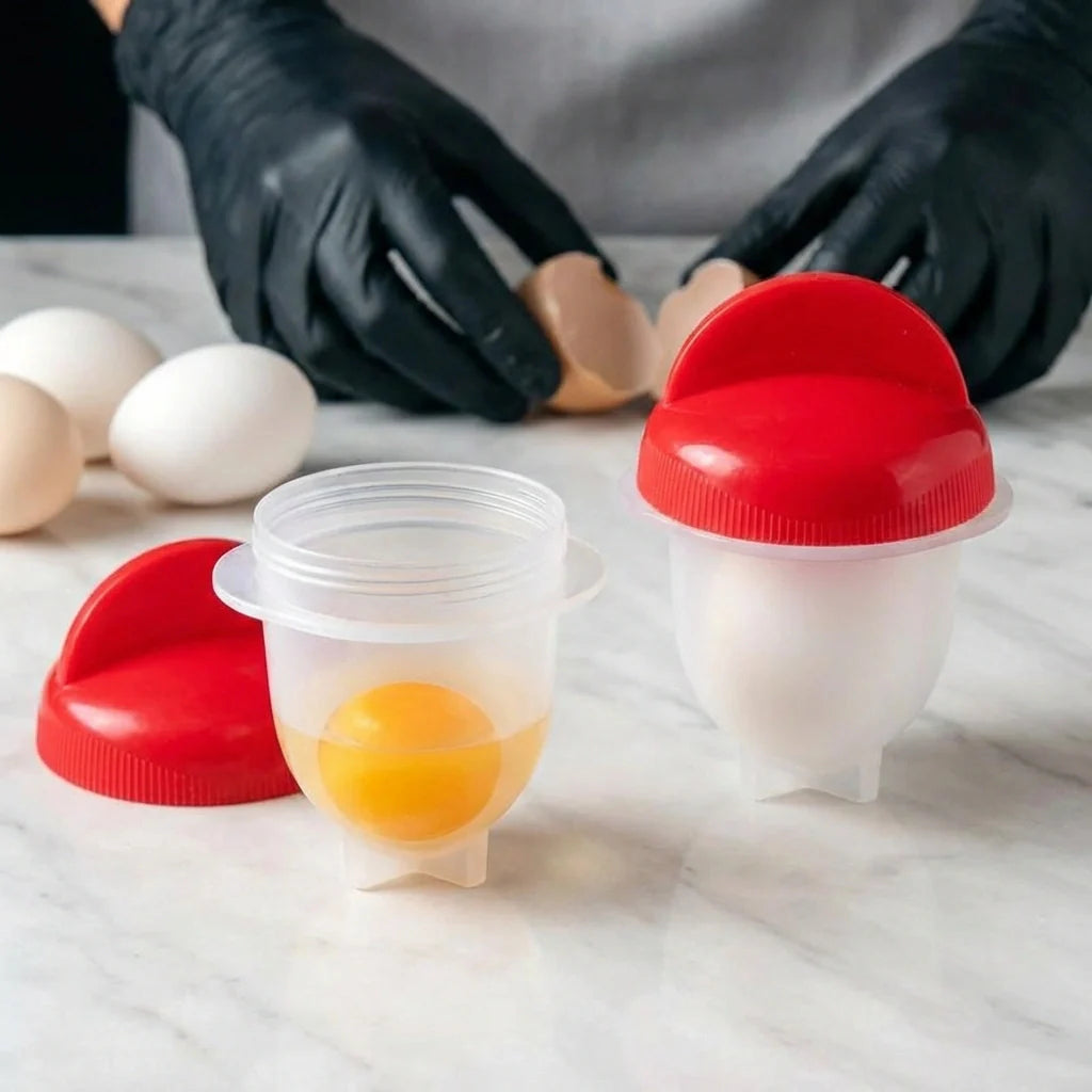 Nonstick egg boiler with clear cups and red lids, shown holding a cracked egg