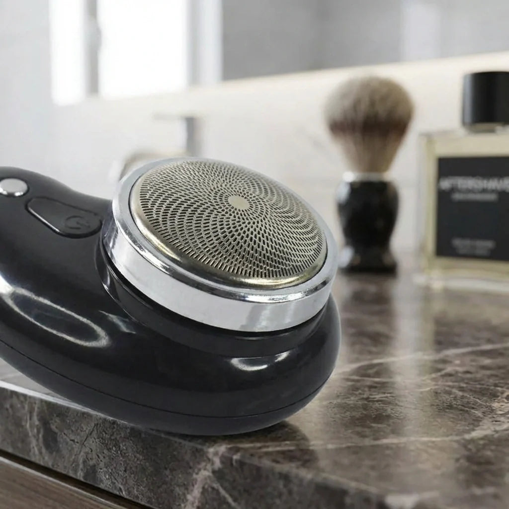 Black electric shaver with circular mesh head