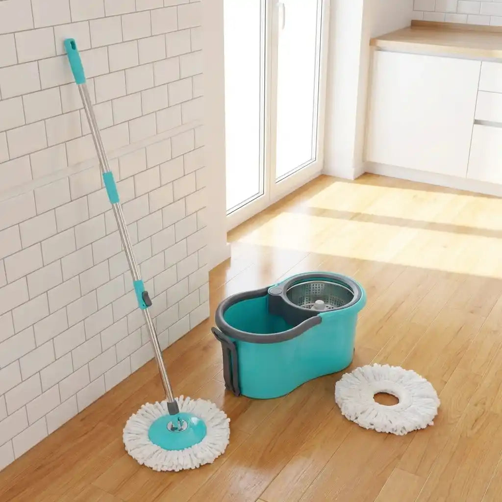 Quick spin mop set with teal bucket and two white microfiber pads on tile floor