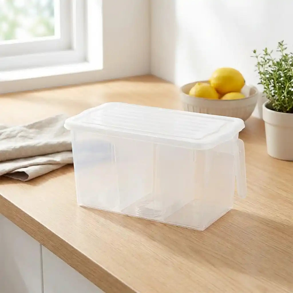 Clear empty refrigerator organizer storage box with lid on a kitchen counter.